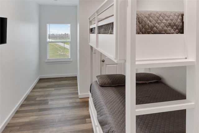 bedroom featuring baseboards and wood finished floors