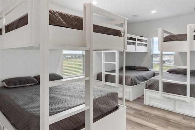 bedroom with wood finished floors and recessed lighting