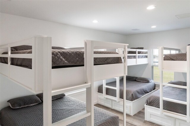 bedroom featuring wood finished floors and recessed lighting