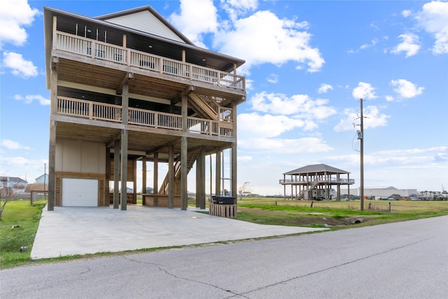 beach home featuring an attached garage, stairs, and a carport