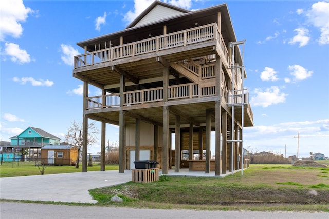 view of front of property featuring a garage, stairway, and a front lawn