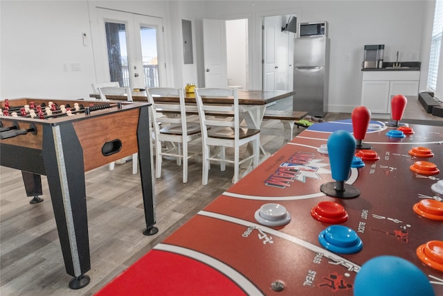 game room with french doors and wood finished floors