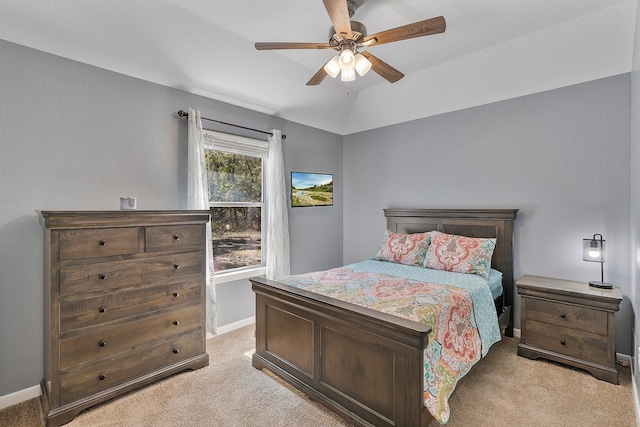 bedroom featuring lofted ceiling, baseboards, a ceiling fan, and light colored carpet