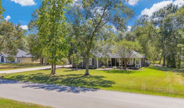 view of front of home with concrete driveway and a front yard