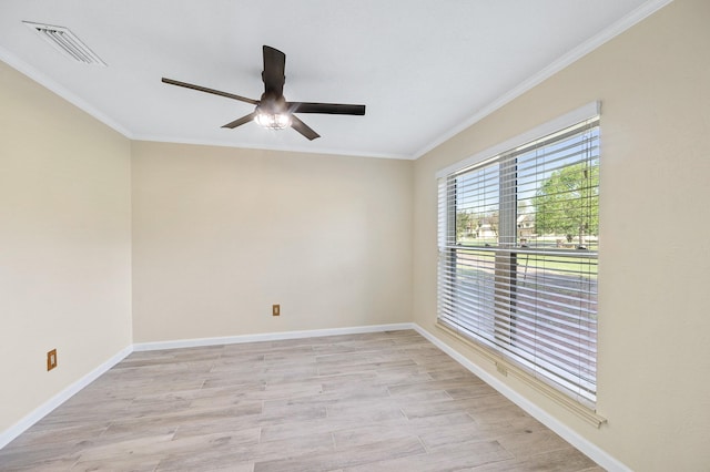 unfurnished room featuring ornamental molding, visible vents, light wood-style floors, and baseboards