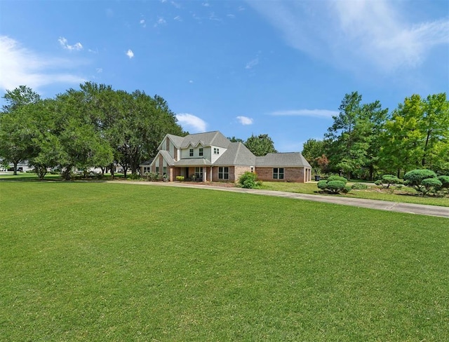 view of front of house featuring a front yard and brick siding