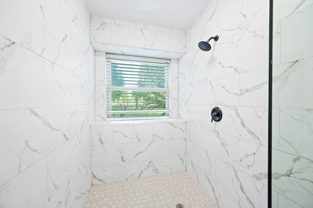 full bath featuring a tile shower