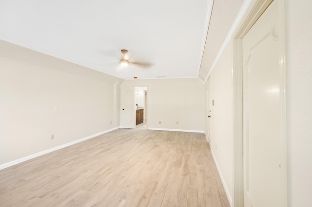 empty room with light wood-style flooring, baseboards, and ceiling fan