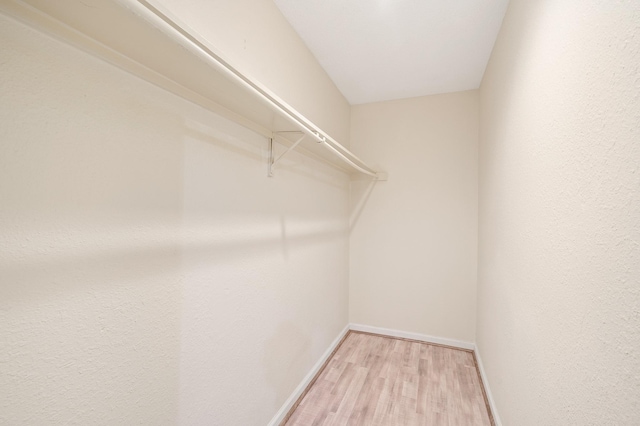 spacious closet with light wood-style floors