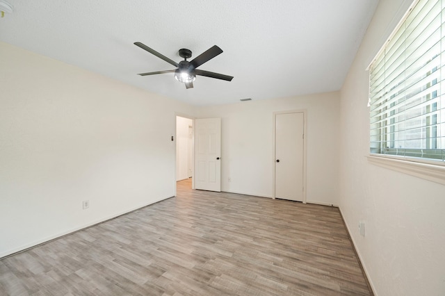 unfurnished bedroom featuring wood finished floors and a ceiling fan