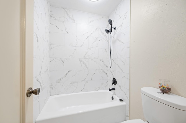 full bathroom with washtub / shower combination, a textured wall, and toilet