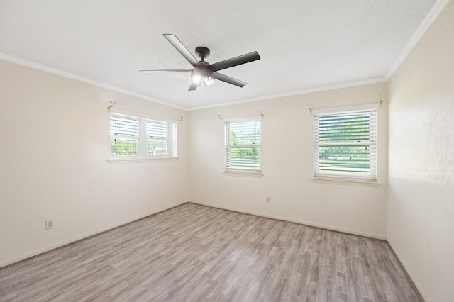 empty room featuring baseboards, a ceiling fan, light wood-style flooring, and crown molding