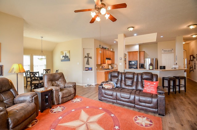 living room featuring light wood finished floors, recessed lighting, vaulted ceiling, ceiling fan, and baseboards