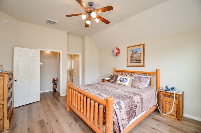 bedroom with light wood-type flooring, baseboards, visible vents, and lofted ceiling