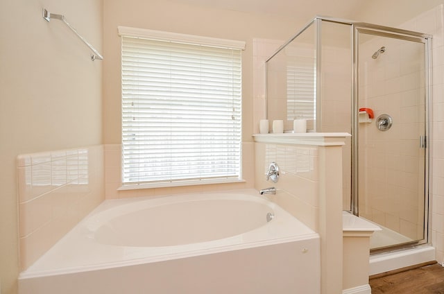 full bath featuring a stall shower and a garden tub