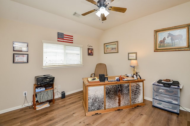 home office with baseboards, visible vents, a ceiling fan, lofted ceiling, and wood finished floors