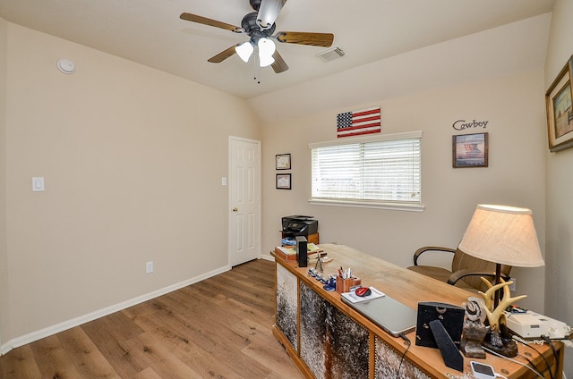 office area featuring lofted ceiling, wood finished floors, a ceiling fan, visible vents, and baseboards