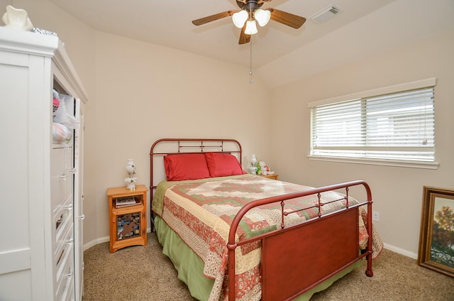 carpeted bedroom featuring baseboards, visible vents, vaulted ceiling, and a ceiling fan