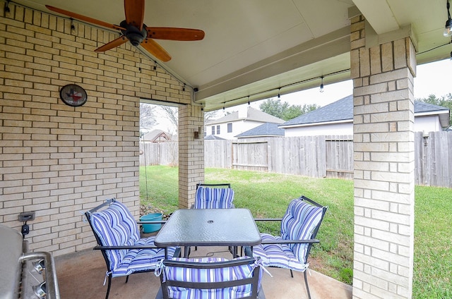 view of patio / terrace featuring outdoor dining area, a fenced backyard, and a ceiling fan