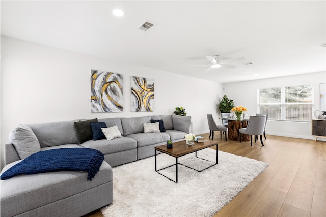 living area with recessed lighting, visible vents, a ceiling fan, wood finished floors, and baseboards