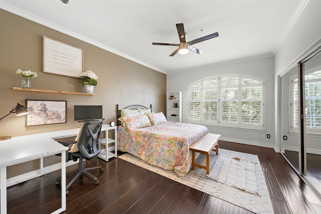 bedroom with ornamental molding, a ceiling fan, baseboards, and wood finished floors