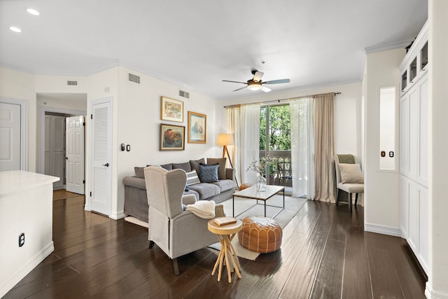 living room with visible vents, dark wood-style flooring, and ornamental molding