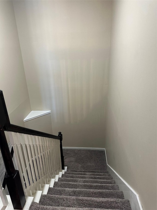 stairway with carpet flooring and baseboards