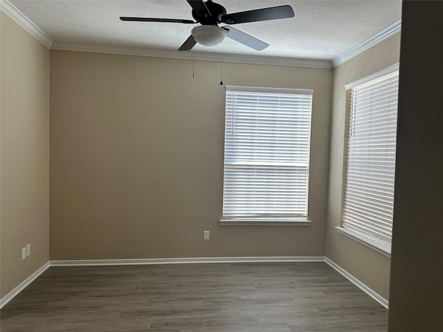 empty room with crown molding, a textured ceiling, and wood finished floors