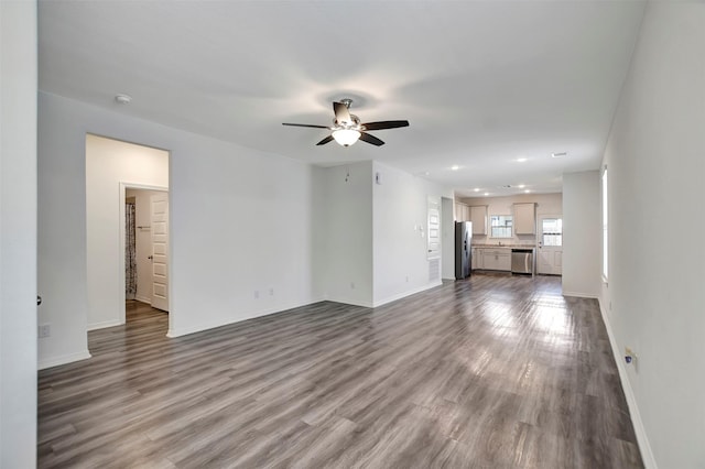 unfurnished living room featuring dark wood-style floors, recessed lighting, baseboards, and a ceiling fan