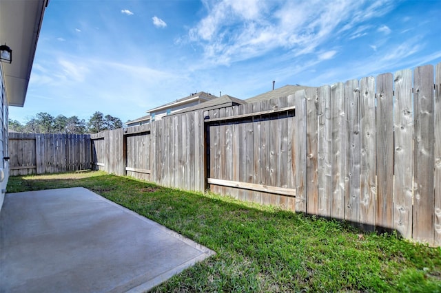 view of yard with a fenced backyard and a patio