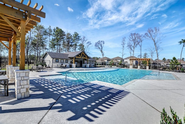 community pool with a patio, fence, and a pergola