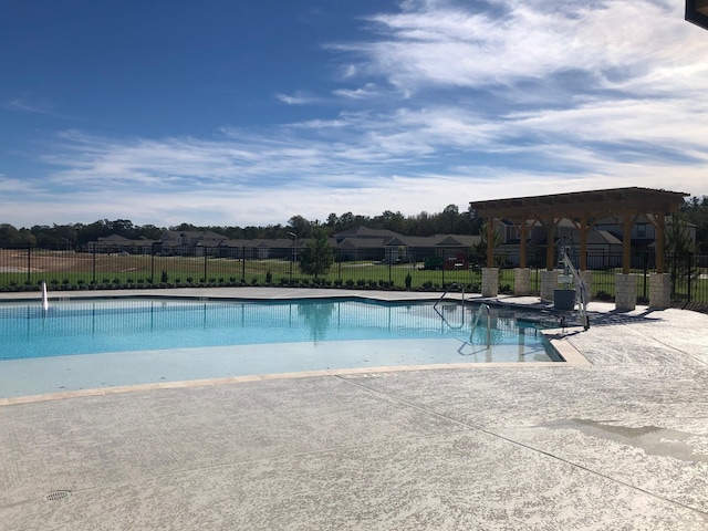 pool featuring fence and a patio