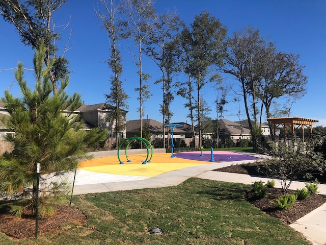 view of property's community featuring playground community and a yard