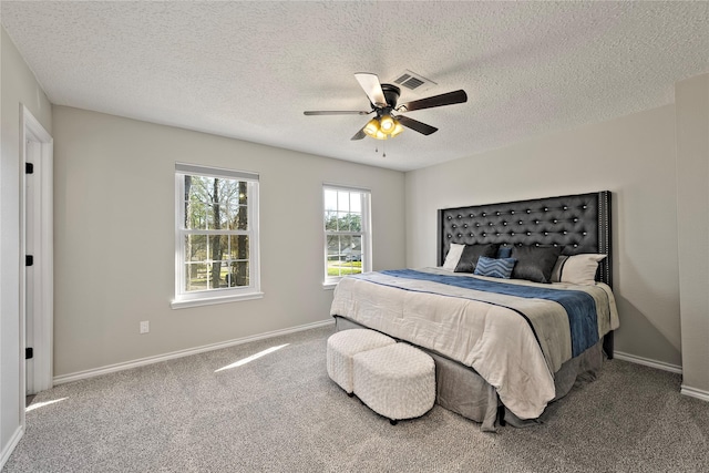 bedroom featuring carpet, visible vents, a ceiling fan, a textured ceiling, and baseboards