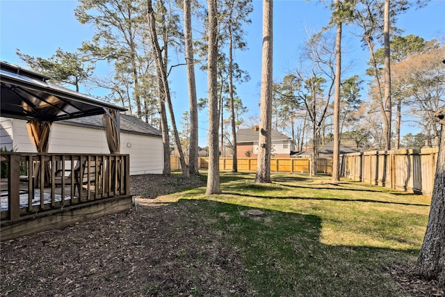 view of yard with a fenced backyard, a deck, and a gazebo