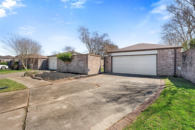 view of front of property with brick siding, an outdoor structure, a detached garage, and fence