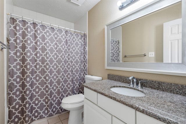 full bath featuring a shower with shower curtain, toilet, vanity, a textured ceiling, and tile patterned flooring