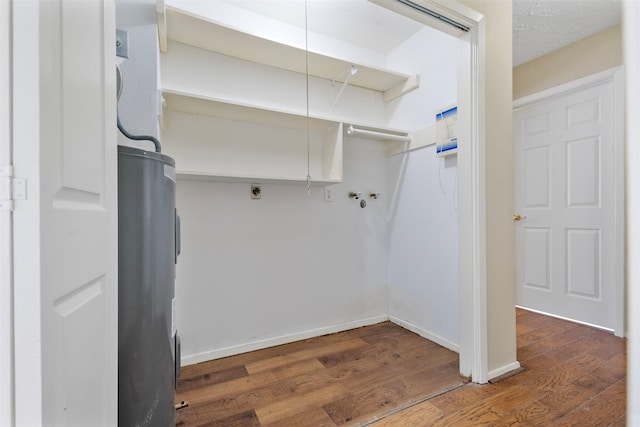 laundry area with hookup for an electric dryer, laundry area, washer hookup, wood finished floors, and water heater