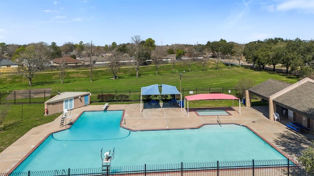 pool featuring a yard, fence, and a patio