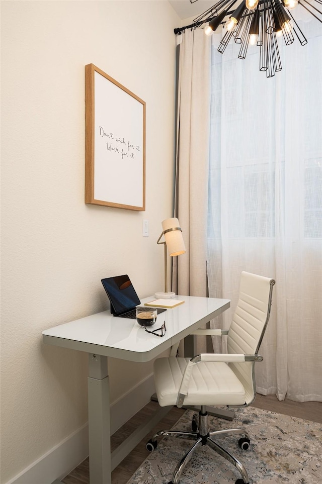 home office featuring an inviting chandelier, baseboards, and wood finished floors