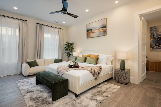 bedroom with recessed lighting, multiple windows, visible vents, and wood finished floors