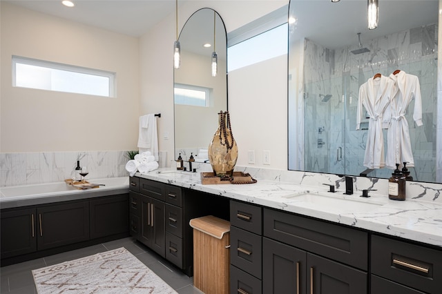 bathroom with double vanity, a shower stall, a sink, and a bath