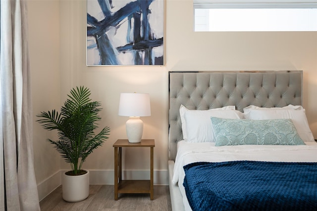 bedroom featuring baseboards and wood finished floors