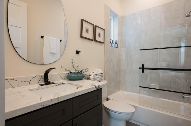 bathroom featuring bathing tub / shower combination, vanity, and toilet