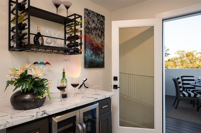 bar with vaulted ceiling, beverage cooler, plenty of natural light, and a dry bar