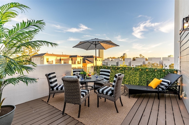 wooden terrace with outdoor dining area