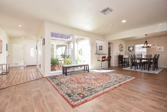 foyer featuring a chandelier, recessed lighting, visible vents, and wood finished floors