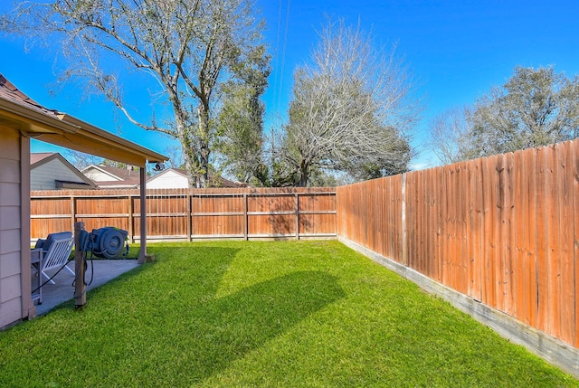 view of yard with a patio area and a fenced backyard