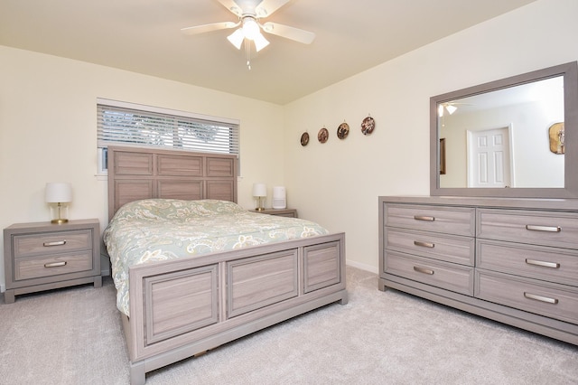 bedroom featuring light carpet, ceiling fan, and baseboards