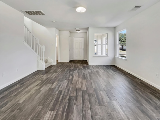 entrance foyer with dark wood-style floors, visible vents, stairway, and baseboards